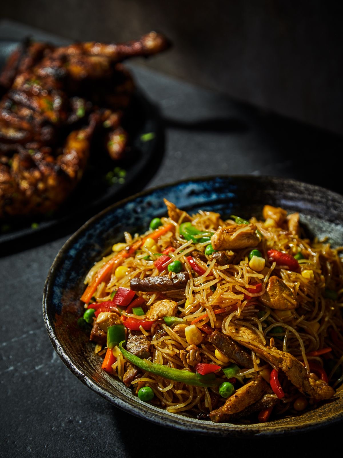 Singapore noodles with chicken and vegetables in a spicy sauce